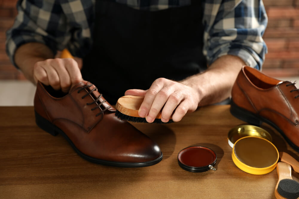 man polishing shoes